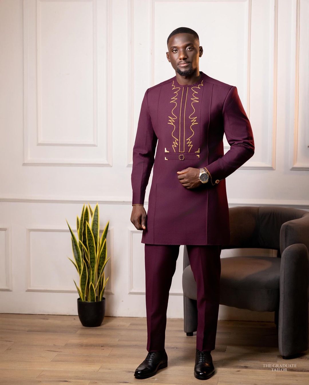 Man wearing a burgundy kaftan and matching trousers with gold embroidery