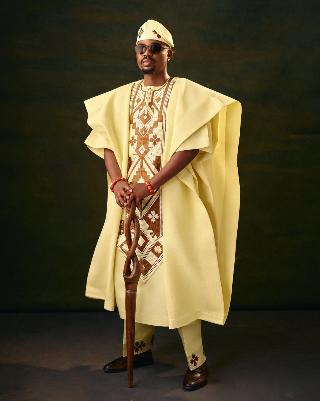 Yellow agbada with brown embroidery and a matching cap